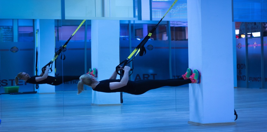 woman exercising with TRX bands