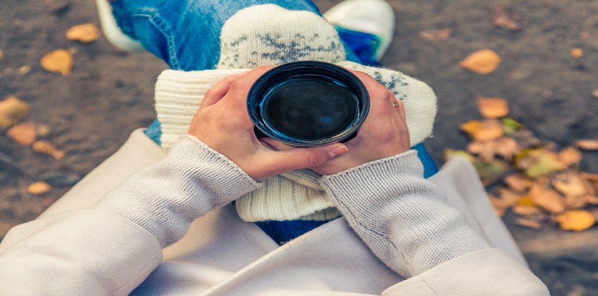 woman holding tea outdoors fall