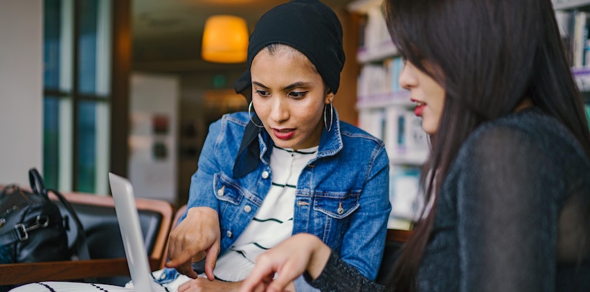 Two women working together at a computer