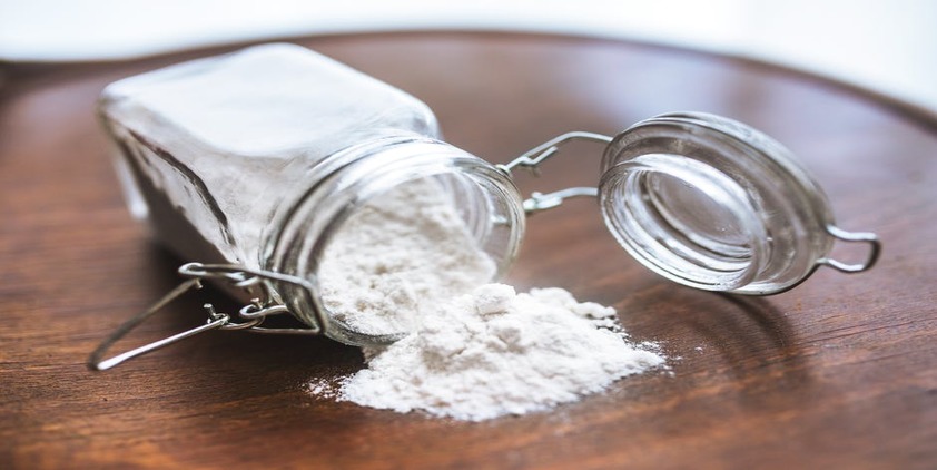 Pexels. Baking Soda in a glass jar spilled onto a wooden table
