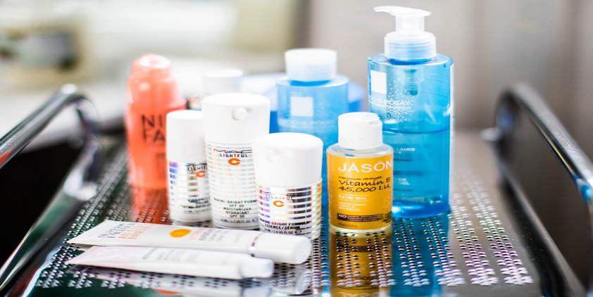 Unsplash. Various bottles of skincare on a metal cart