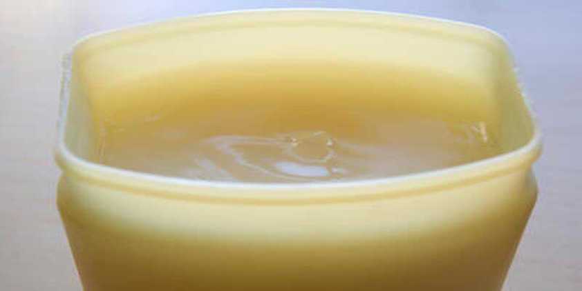 Corbis Petroleum Jelly in a yellow container on a white surface