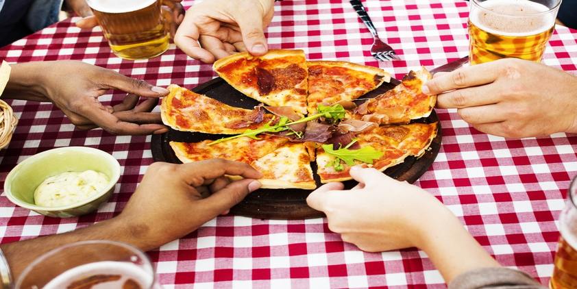 unsplash people at red checkered table with pizza and beer