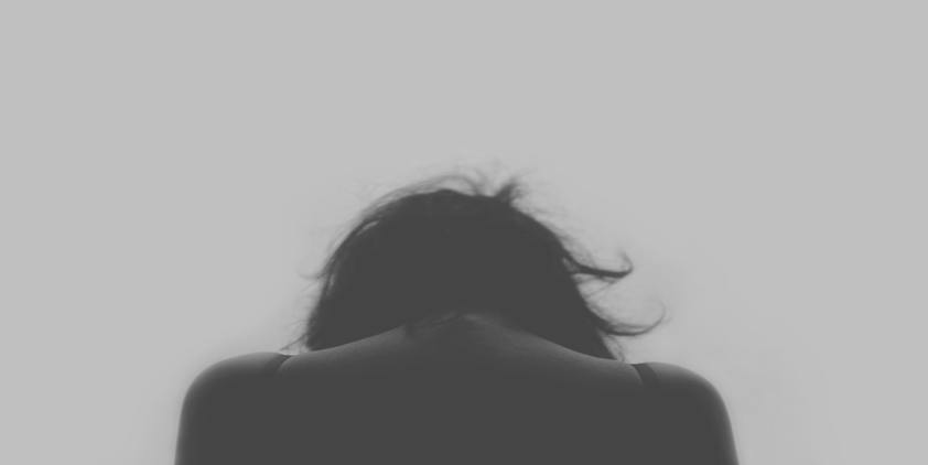 unsplash. woman with black hair looking down