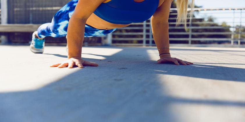 unsplash. woman planking on concrete.