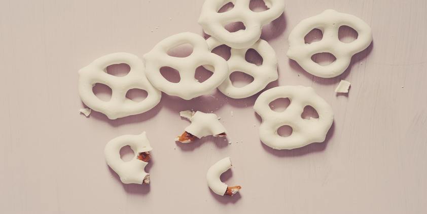 unsplash. yogurt covered pretzels on a white surface