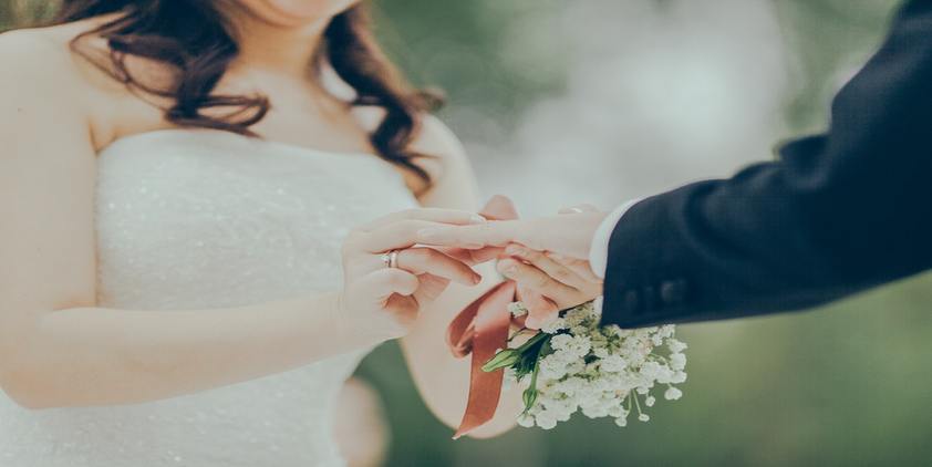 unsplash. woman giving wedding ring to man