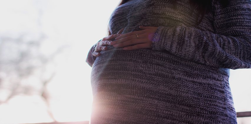 pregnant woman holding belly