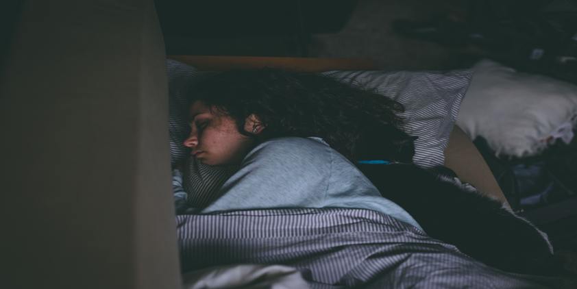 Pexels. Woman sleeping with cat in bed
