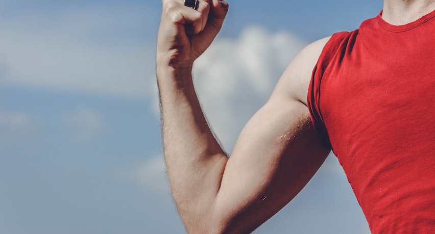 A man flexes his biceps