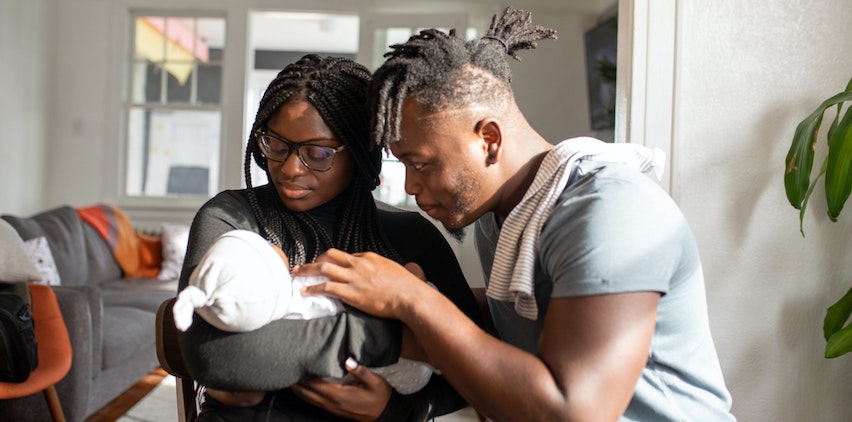 A man and a woman caring for a baby